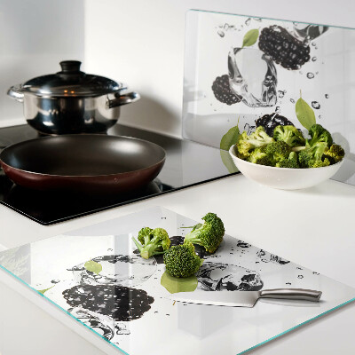 Glass cutting board Raspberries with leaves and drops of water