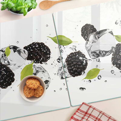 Glass cutting board Raspberries with leaves and drops of water