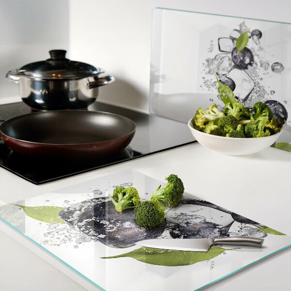 Glass kitchen board Plums in water with leaves
