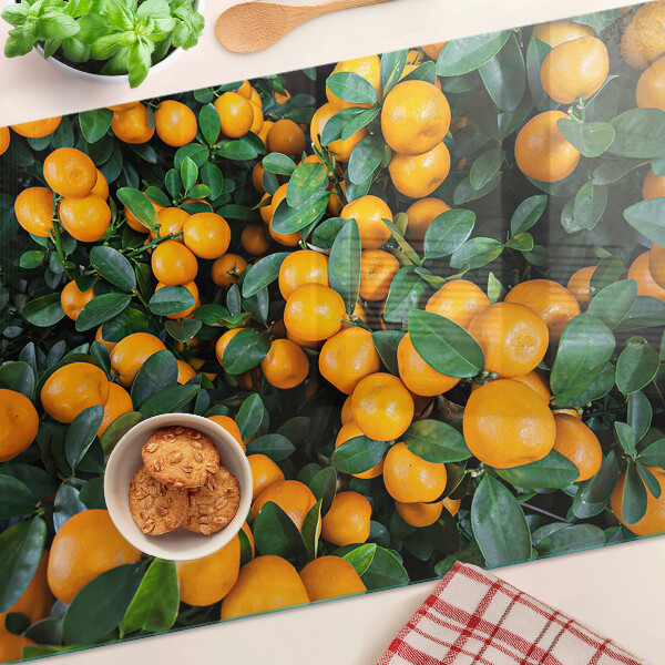 Glass cutting board Mandarins on the branches