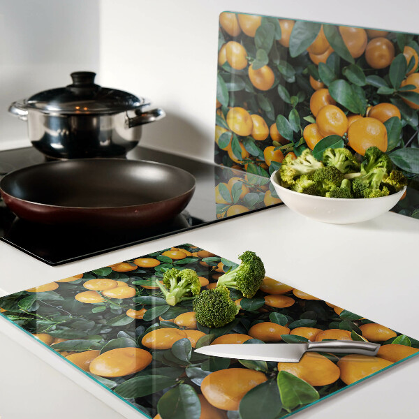Glass cutting board Mandarins on the branches