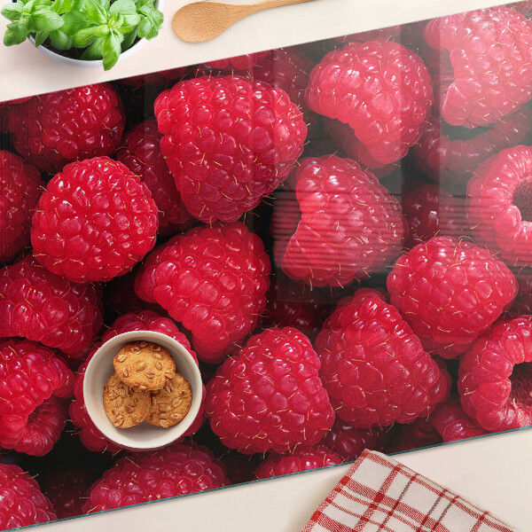 Chopping board Raspberries on the background