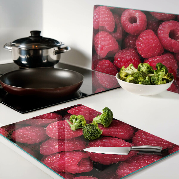 Chopping board Raspberries on the background