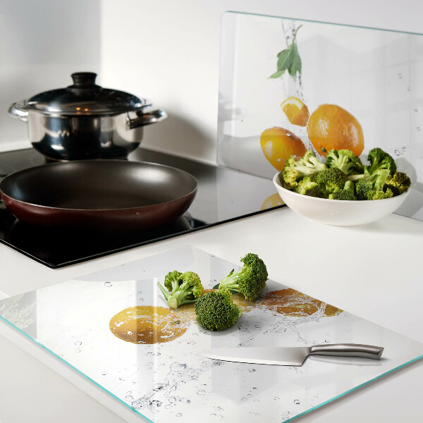 Chopping board glass Citrus fruits with water