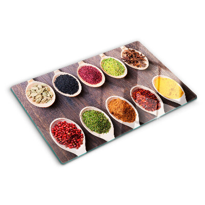 Glass chopping board Spices in spoons