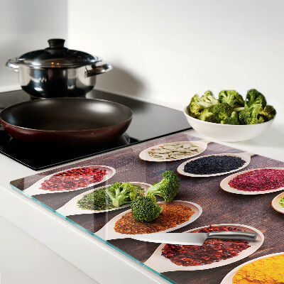 Glass chopping board Spices in spoons