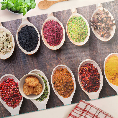 Glass chopping board Spices in spoons
