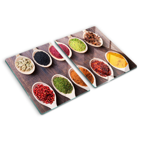 Glass chopping board Spices in spoons
