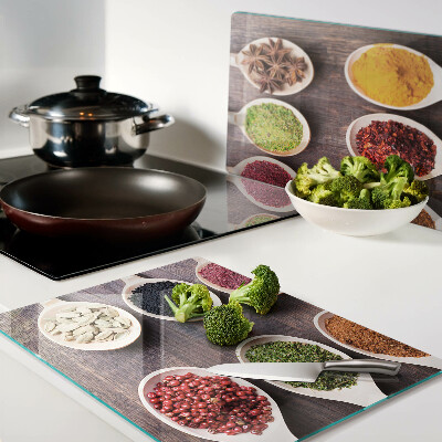 Glass chopping board Spices in spoons