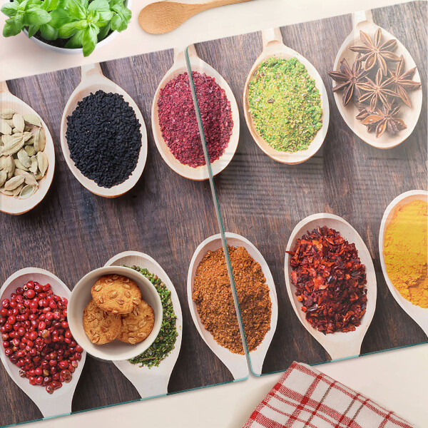 Glass chopping board Spices in spoons