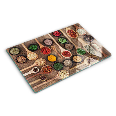 Glass cutting board Spices and herbs in spoons