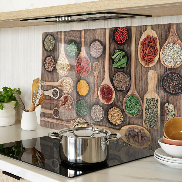 Glass cutting board Spices and herbs in spoons