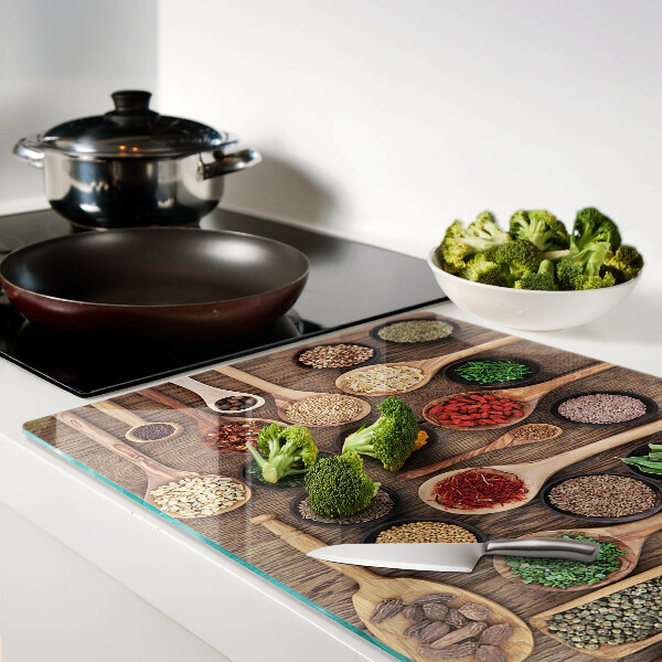 Glass cutting board Spices and herbs in spoons