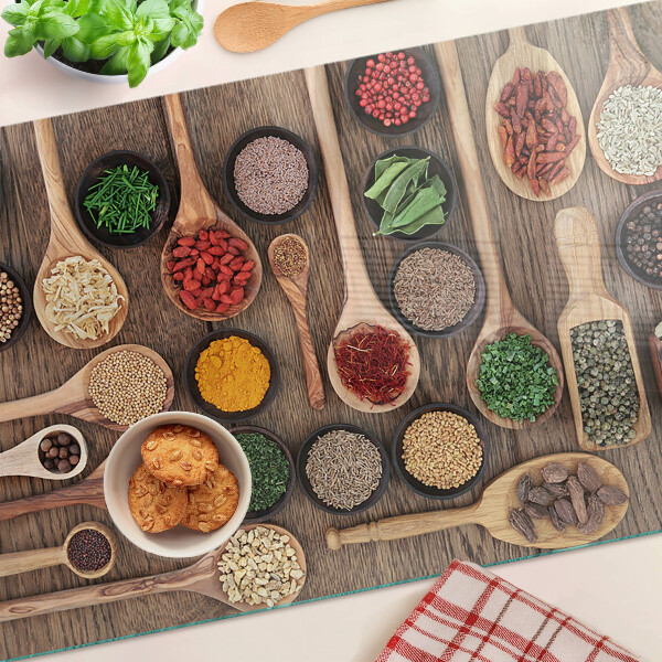 Glass cutting board Spices and herbs in spoons