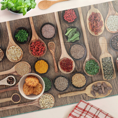 Glass cutting board Spices and herbs in spoons
