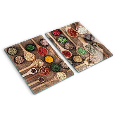 Glass cutting board Spices and herbs in spoons