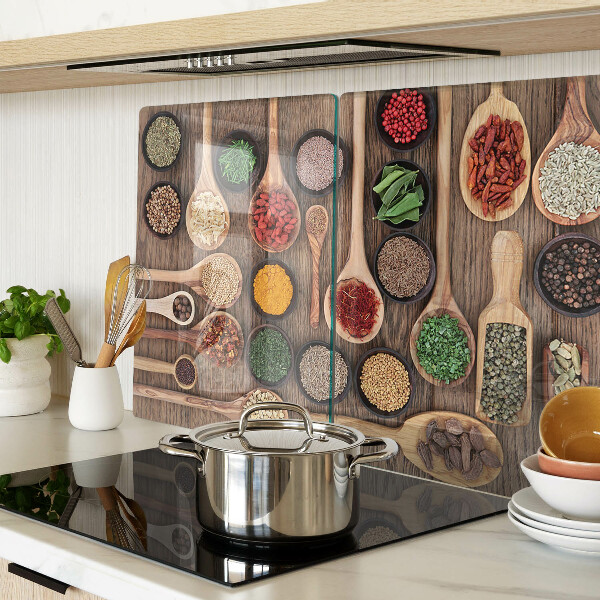 Glass cutting board Spices and herbs in spoons