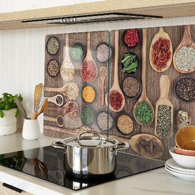 Glass cutting board Spices and herbs in spoons