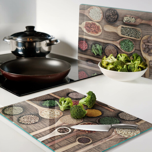 Glass cutting board Spices and herbs in spoons