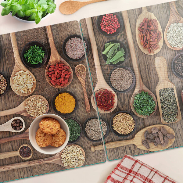 Glass cutting board Spices and herbs in spoons