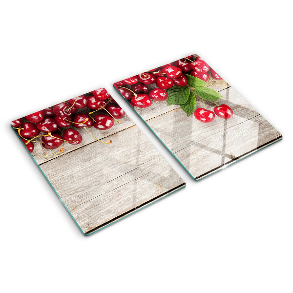 Glass cutting board Cherries on a wooden background