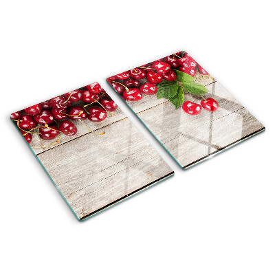 Glass cutting board Cherries on a wooden background