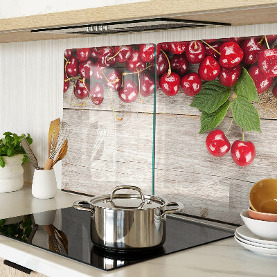 Glass cutting board Cherries on a wooden background