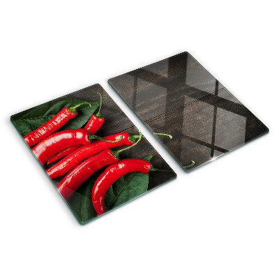 Glass cutting board Chili peppers on a wooden background