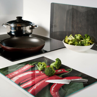 Glass cutting board Chili peppers on a wooden background