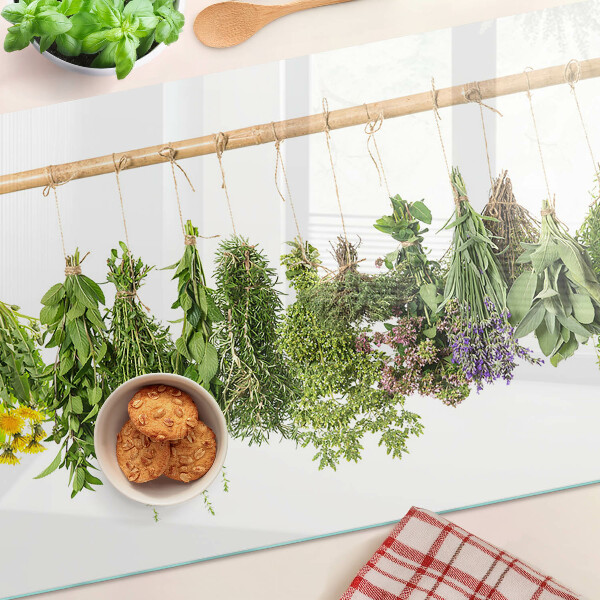 Glass kitchen board Dried herbs on a string