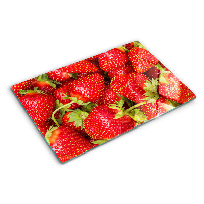 Glass chopping board Strawberries on the background