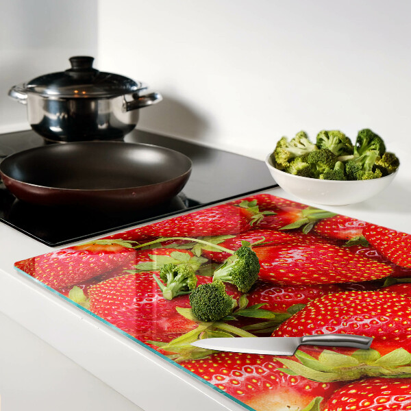Glass chopping board Strawberries on the background