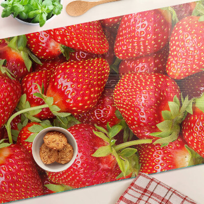 Glass chopping board Strawberries on the background