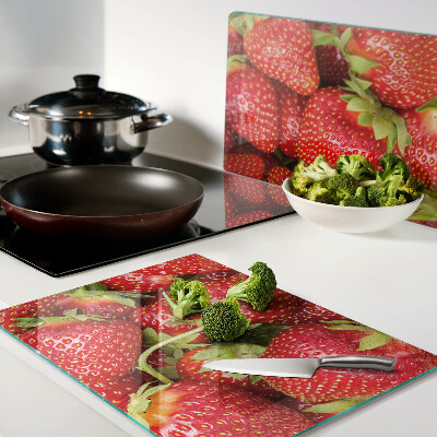 Glass chopping board Strawberries on the background