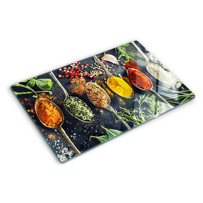 Glass cutting board Spices in spoons