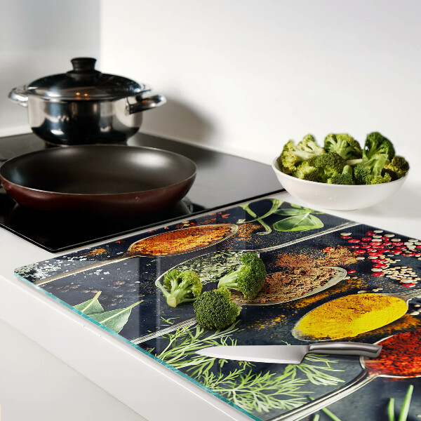 Glass cutting board Spices in spoons