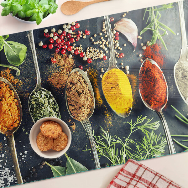 Glass cutting board Spices in spoons