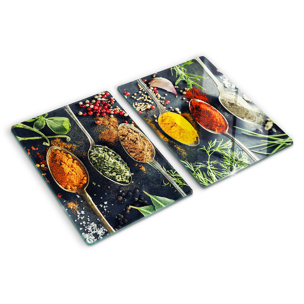 Glass cutting board Spices in spoons