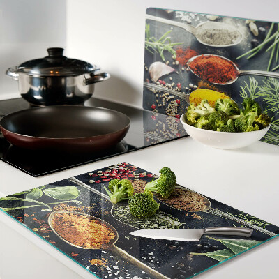 Glass cutting board Spices in spoons