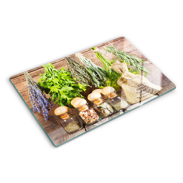 Chopping board glass Herbs and spices on a wood background