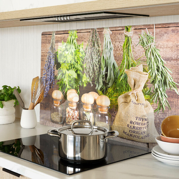 Chopping board glass Herbs and spices on a wood background