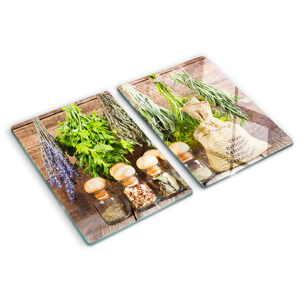 Chopping board glass Herbs and spices on a wood background