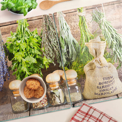 Chopping board glass Herbs and spices on a wood background