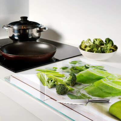 Glass chopping board Green smoothie with fresh ingredients