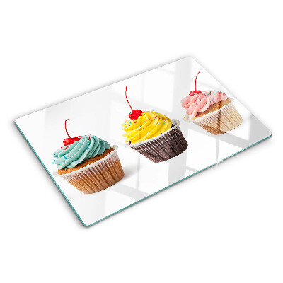Chopping board glass Cupcake with whipped cream and cherry
