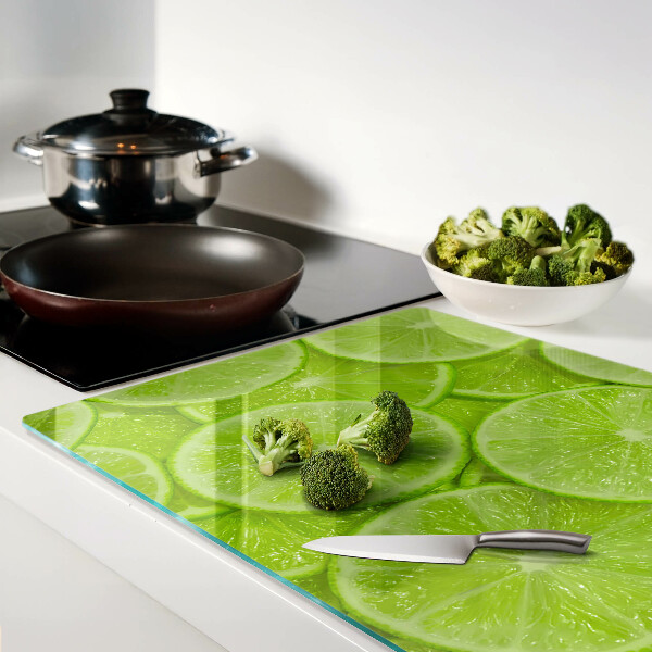 Cutting board Lime slices on a green background