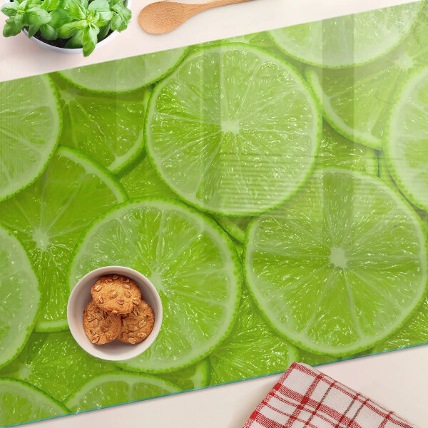 Cutting board Lime slices on a green background