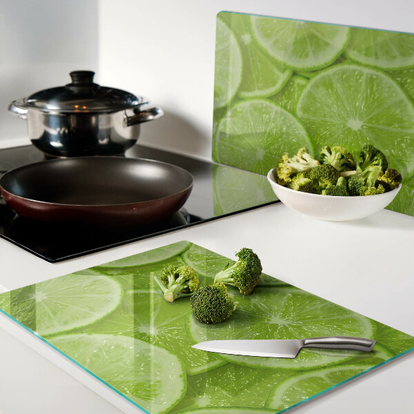 Cutting board Lime slices on a green background
