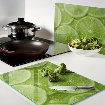 Cutting board Lime slices on a green background