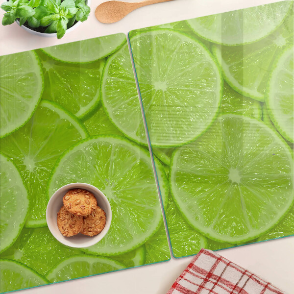 Cutting board Lime slices on a green background
